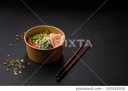 An Asian style bowl with shrimp, edamame, tomatoes, and wakame. A shrimp and vegetable bowl An Asian style bowl with shrimp, edamame, tomatoes, and wakame. A shrimp and vegetable bowl 142938308