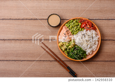An Asian style bowl with shrimp, edamame, tomatoes, and wakame. A shrimp and vegetable bowl An Asian style bowl with shrimp, edamame, tomatoes, and wakame. A shrimp and vegetable bowl 142938310