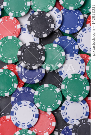 Multi colored gaming chips for betting in casino games. Betting chips Multi colored gaming chips for betting in casino games. Betting chips 142938335