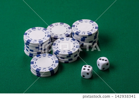 Multicolored casino chips as a conceptual backdrop for gambling games like poker, blackjack 142938341
