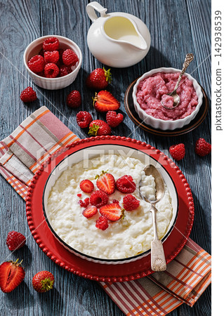 Rice pudding in a bowl topped with berries Rice pudding in a bowl topped with berries 142938539