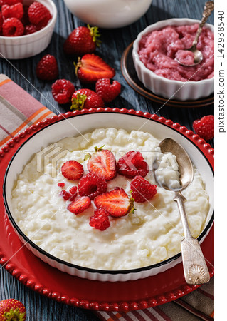 Milchreis german milk rice pudding with berries Milchreis german milk rice pudding with berries 142938540