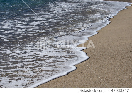 Ocean Surf and White Foam Along Golden Sandy Shore Ocean Surf and White Foam Along Golden Sandy Shore 142938847