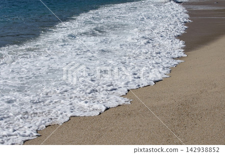 Powerful Foamy Sea Wave Washing onto Sandy Beach Powerful Foamy Sea Wave Washing onto Sandy Beach 142938852