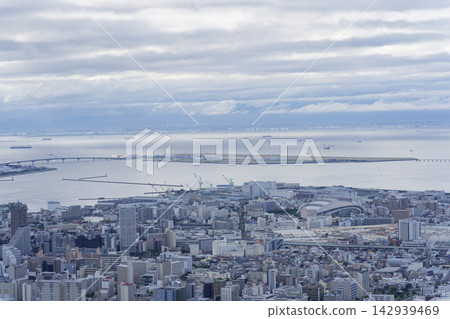 A view of Kobe's cityscape and harbor from a hilltop. A view of Kobe's cityscape and harbor from a hilltop. 142939469