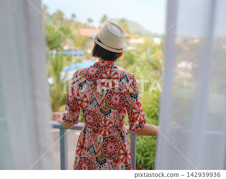 Young woman smiling on a balcony 142939936