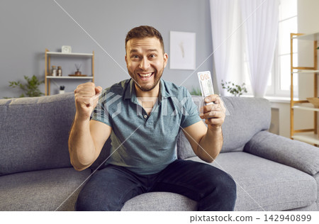 Happy Man Celebrating Financial Success With Stack Of Cash 142940899