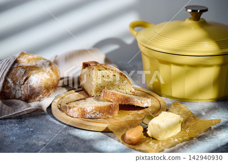 Sliced rustic sourdough bread showing airy crumb texture on wooden board Sliced rustic sourdough bread showing airy crumb texture on wooden board 142940930