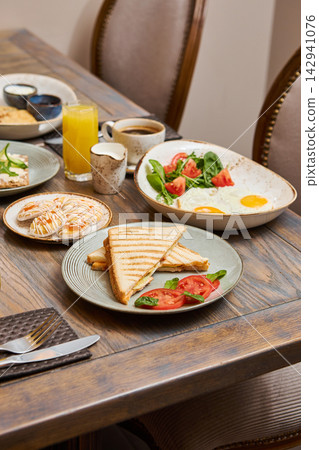 Breakfast Table with Syrniki, Fried Eggs, Toasts and Beverages Breakfast Table with Syrniki, Fried Eggs, Toasts and Beverages 142941076