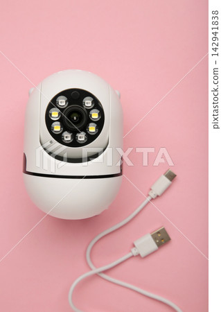 Security camera on pink background. Outdoor surveillance camera. Vertical photo 142941838