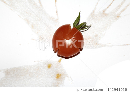 A squashed splattered and crushed broken fresh tomato with seeds A squashed splattered and crushed broken fresh tomato with seeds 142941936