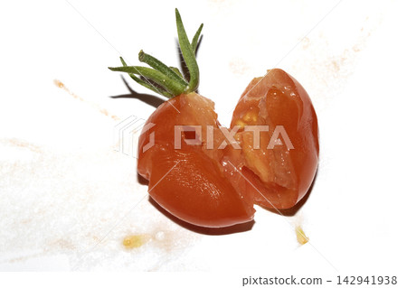 A squashed splattered and crushed broken fresh tomato with seeds 142941938