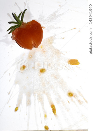 A squashed splattered and crushed broken fresh tomato with seeds A squashed splattered and crushed broken fresh tomato with seeds 142941940