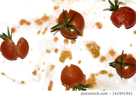 A squashed splattered and crushed broken fresh tomato with seeds A squashed splattered and crushed broken fresh tomato with seeds 142941941