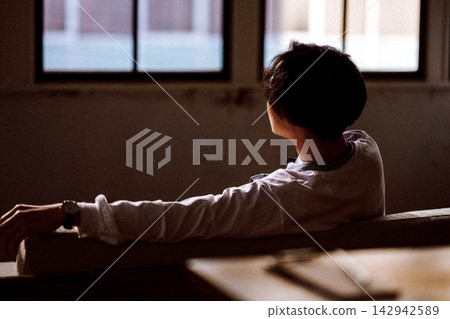A man relaxing by the window, wearing a watch. A man relaxing by the window, wearing a watch. 142942589