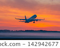 Take off of passenger aircraft at picturesque dawn with a fog 142942677