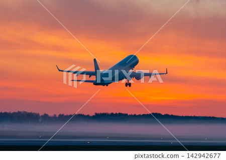 Take off of passenger aircraft at picturesque dawn with a fog Take off of passenger aircraft at picturesque dawn with a fog 142942677