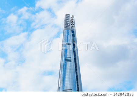 Seoul, South Korea - Sep. 18, 2026 : Lotte World Tower reaching into the clear blue sky with white clouds in Seoul, South Korea Seoul, South Korea - Sep. 18, 2026 : Lotte World Tower reaching into the clear blue sky with white clouds in Seoul, South Korea 142942853
