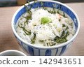 Bowl of rice topped with sashimi  142943651