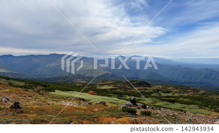 A vast mountain panorama overlooking the Daisetsuzan mountain range of Hokkaido. A vast mountain panorama overlooking the Daisetsuzan mountain range of Hokkaido. 142943934