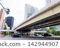 A view of the cityscape and buildings towards Shiodome and Shinbashi from Horai Bridge: urban infrastructure and office district scenery. 142944907