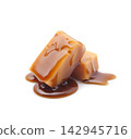Caramel candies with caramel topping on white backgrounds 142945716