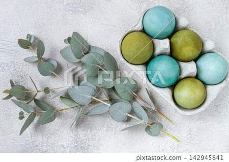 Easter colored eggs, in green and turquoise tones, with eucalyptus leaves, Easter card, top view, no people, Easter colored eggs, in green and turquoise tones, with eucalyptus leaves, Easter card, top view, no people, 142945841
