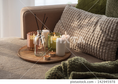 Home interior decor setup with scented candles and diffuser on a tray cozy atmosphere Home interior decor setup with scented candles and diffuser on a tray cozy atmosphere 142945978