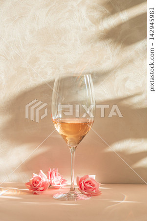 Elegant wine glass with rose petals bathed in soft, warm, natural light Elegant wine glass with rose petals bathed in soft, warm, natural light 142945981