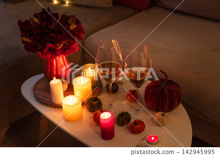 Cozy Autumn Evening Scene With Wine Glasses Candles And Decorative Pumpkins Cozy Autumn Evening Scene With Wine Glasses Candles And Decorative Pumpkins 142945995