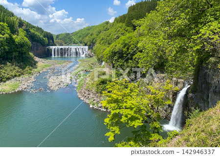 The lush greenery of the Shinda Waterfall and the ruins of a power plant The lush greenery of the Shinda Waterfall and the ruins of a power plant 142946337