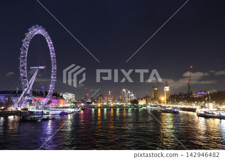 Nighttime view of London Eye over the River Thames Nighttime view of London Eye over the River Thames 142946482