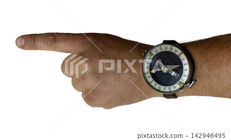 Hand wearing a vintage magnetic navigation compass pointing to the left side Hand wearing a vintage magnetic navigation compass pointing to the left side 142946495