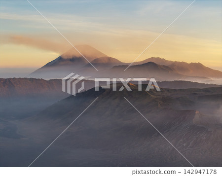 Mount Bromo Volcanic Peaks Emerging Through Mist at Sunset Mount Bromo Volcanic Peaks Emerging Through Mist at Sunset 142947178