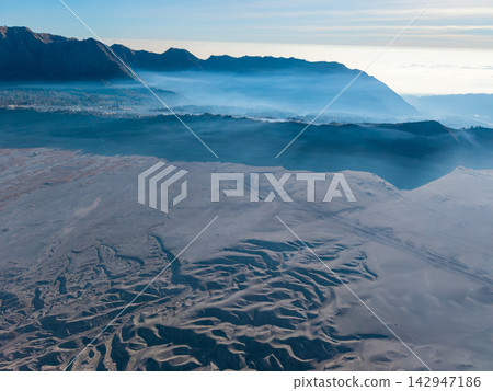 Bromo Hill Panorama Across Mountain Ridges and Misty Indonesian Highlands Bromo Hill Panorama Across Mountain Ridges and Misty Indonesian Highlands 142947186