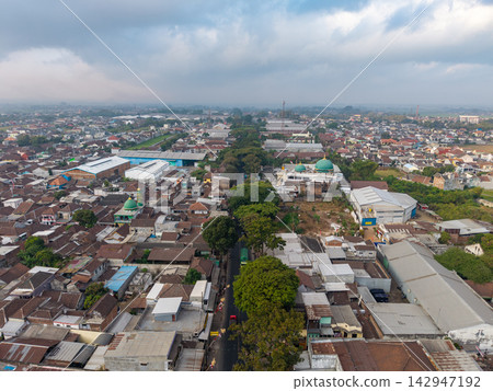 Overcast sky looms above sprawling urban sprawl 142947192