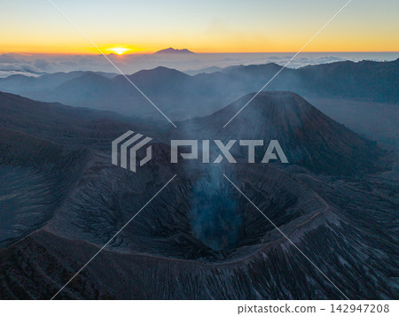 Misty volcano breathes smoke into dawn soft glow Misty volcano breathes smoke into dawn soft glow 142947208