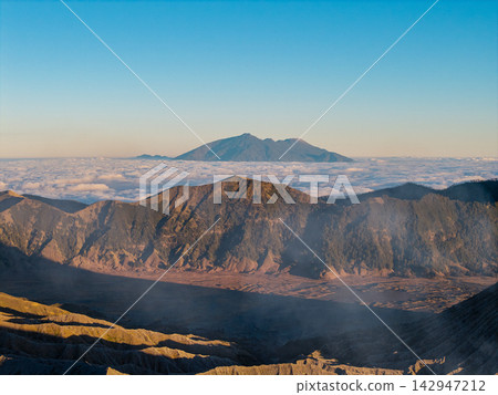 Mountains rise above a sea of clouds Mountains rise above a sea of clouds 142947212