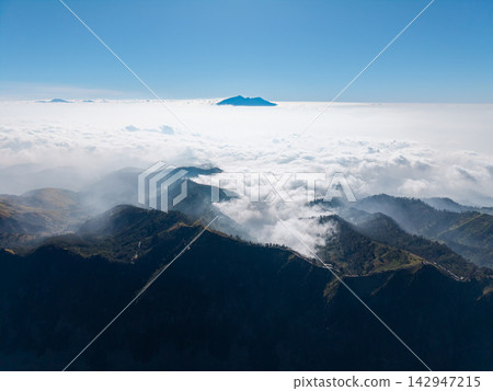 Majestic peaks pierce cloud sea below Majestic peaks pierce cloud sea below 142947215