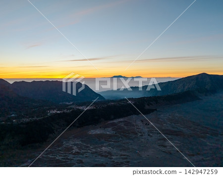 Sunrise paints sky in gold and blue Sunrise paints sky in gold and blue 142947259