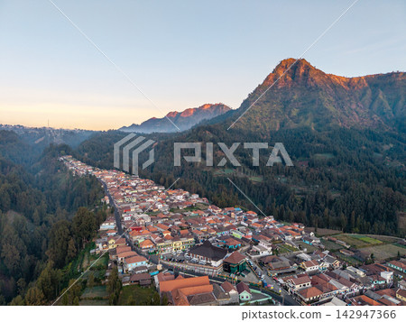 Mountain village nestles in forested valley Mountain village nestles in forested valley 142947366