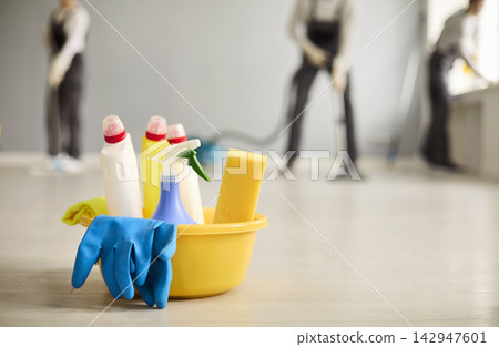 Professional cleaners team with bucket and supplies on floor during service Professional cleaners team with bucket and supplies on floor during service 142947601