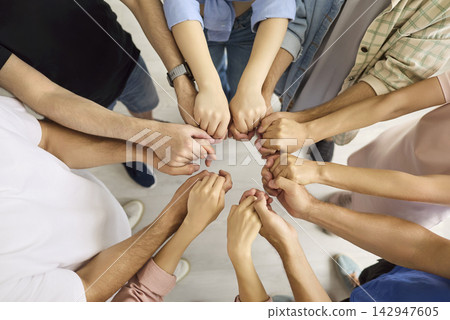 Diverse Team Joining Fists in Circle for Unity, Collaboration and Support Diverse Team Joining Fists in Circle for Unity, Collaboration and Support 142947605