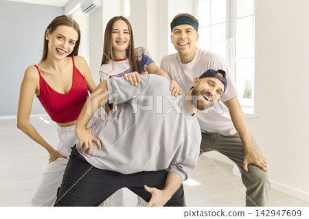 Smiling Diverse Friends Dancing Together During Hip Hop Class in Bright Studio Smiling Diverse Friends Dancing Together During Hip Hop Class in Bright Studio 142947609