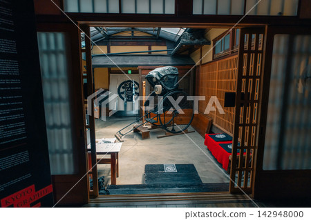 Interior of a traditional Japanese house or museum styled after the samurai era, featuring wooden architecture, tatami flooring, and sliding shoji doors. Interior of a traditional Japanese house or museum styled after the samurai era, featuring wooden architecture, tatami flooring, and sliding shoji doors. 142948000