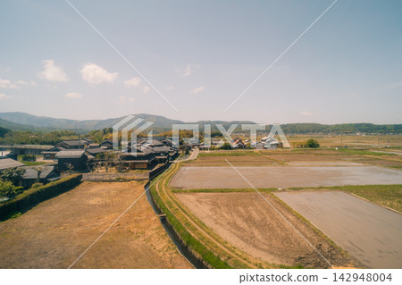 Rural Japanese countryside landscape, likely in Kanagawa Prefecture, featuring traditional villages, green fields, and surrounding natural scenery. Rural Japanese countryside landscape, likely in Kanagawa Prefecture, featuring traditional villages, green fields, and surrounding natural scenery. 142948004
