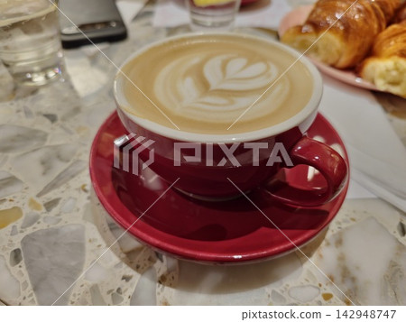 Red Cup of Cappuccino with Latte Art in Cordoba Cafe Red Cup of Cappuccino with Latte Art in Cordoba Cafe 142948747