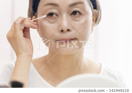 Senior woman doing skin care Senior woman doing skin care 142949228