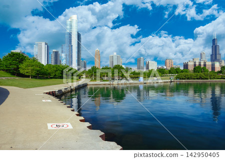 Chicago Skyline Viewed from Lakefront Park on a Sunny Day with Clouds Chicago Skyline Viewed from Lakefront Park on a Sunny Day with Clouds 142950405
