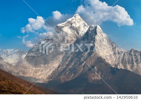Majestic Himalayan mountain peak with snow and clouds in Nepal Majestic Himalayan mountain peak with snow and clouds in Nepal 142950610